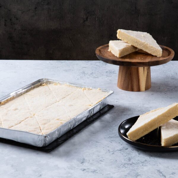 Shortbread slices in a baking tray and on plates.