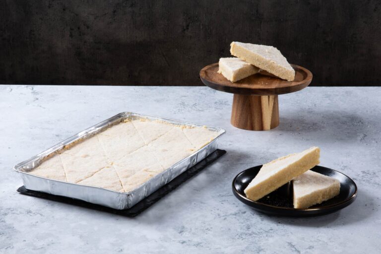 Shortbread slices in a baking tray and on plates.