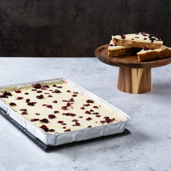 Cranberry blondie traybake with white chocolate topping.
