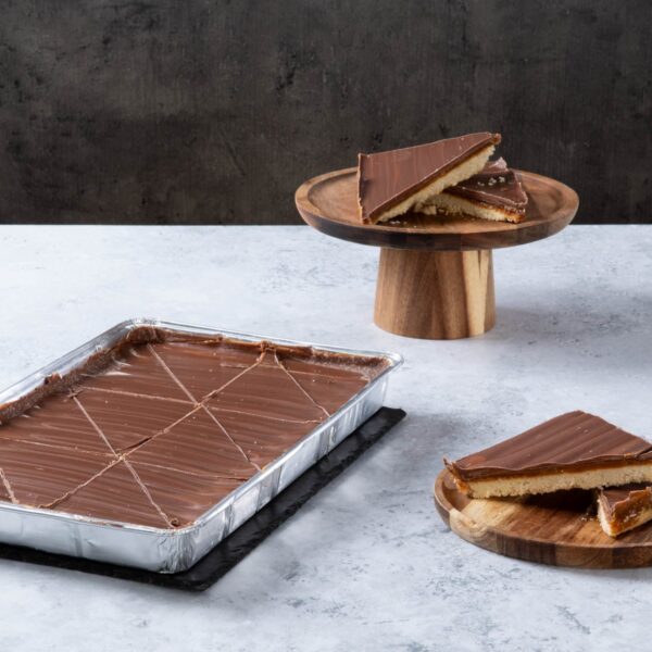 Chocolate caramel shortbread traybake with sliced pieces.