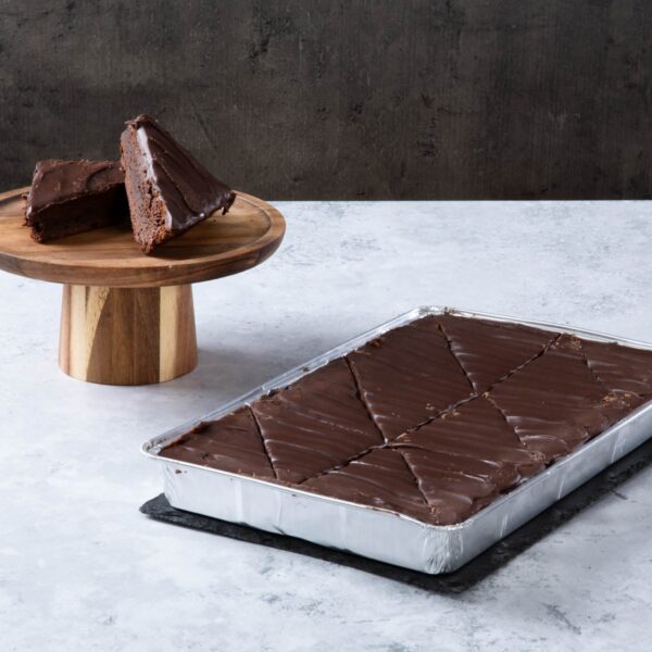 Chocolate fudge cake slices with chocolate frosting in a baking tray.