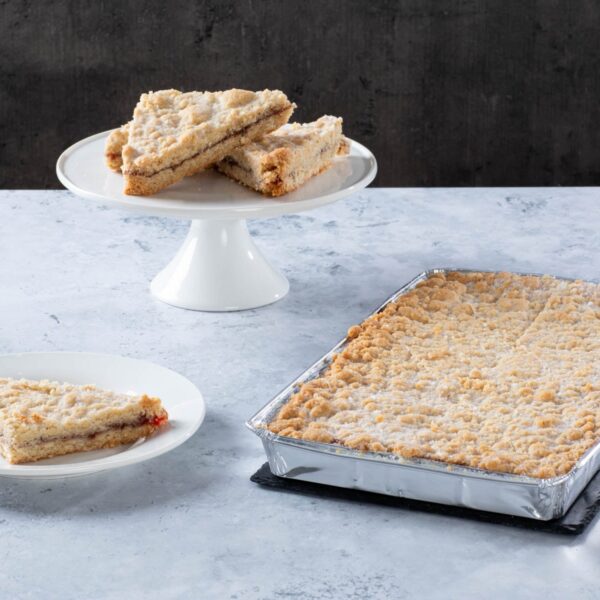 a crumb-topped traybake with sliced pieces on plates