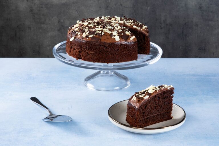 Chocolate cake with chocolate icing and white chocolate shavings.