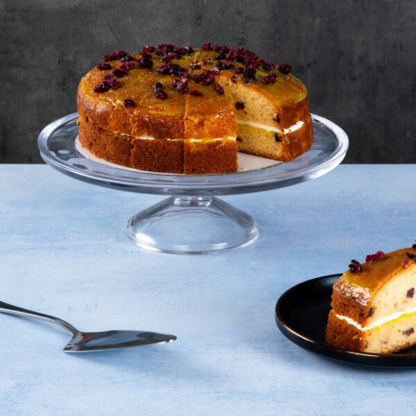 Carrot cake with cream cheese frosting and walnut topping.
