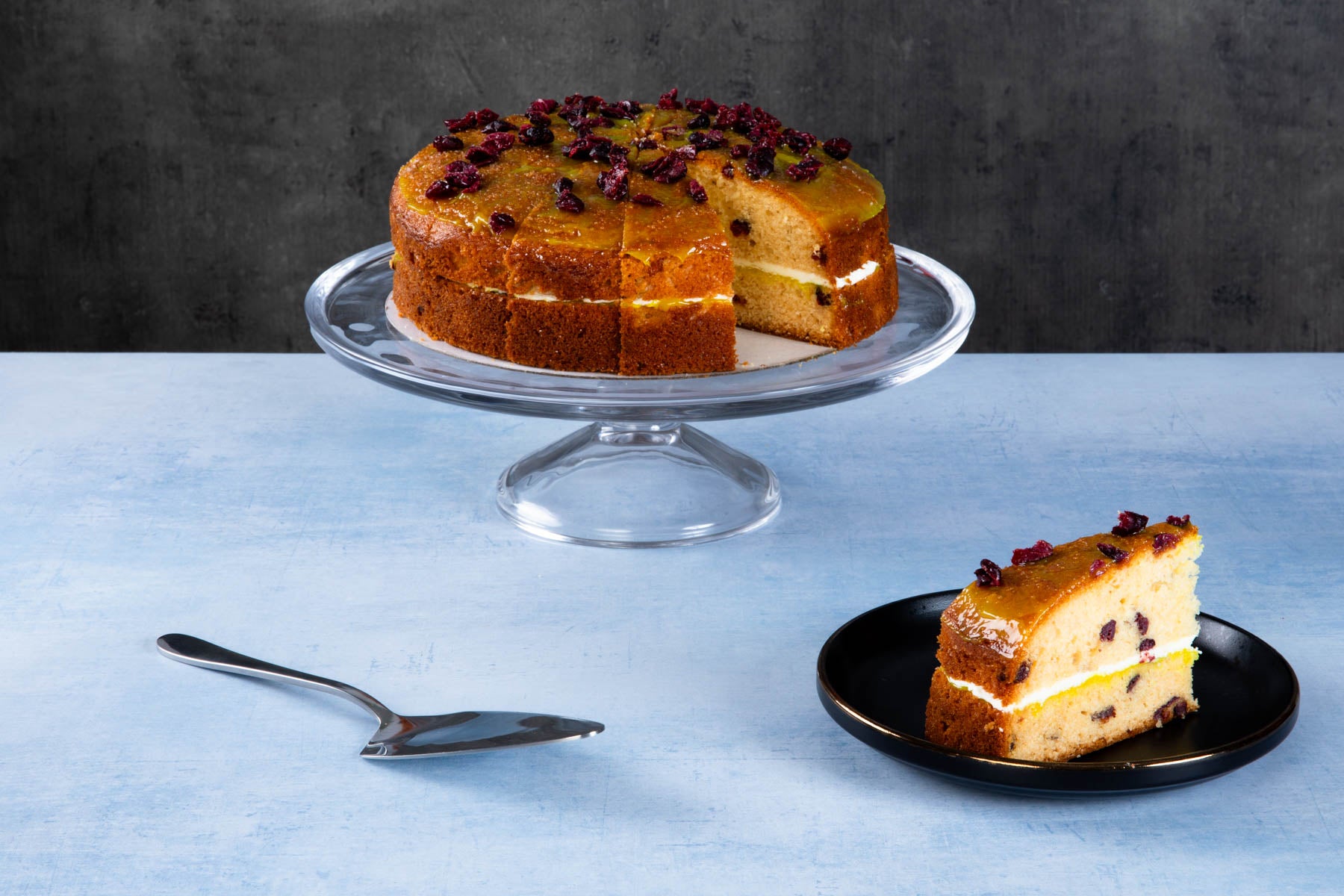 Carrot cake with cream cheese frosting and walnut topping.