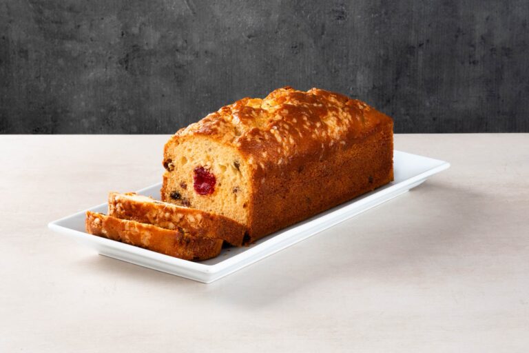 Sliced fruit and cherry loaf cake with glazed crust