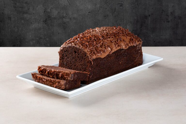 Chocolate loaf cake with chocolate icing and sliced pieces.