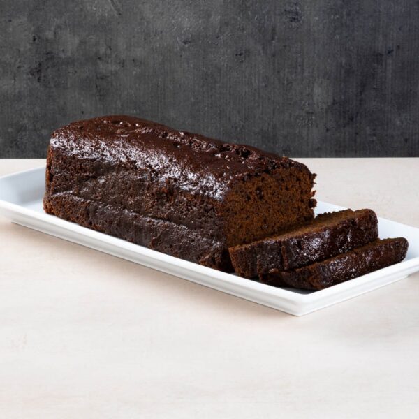 Sliced coffee loaf cake with buttercream and chocolate buttons