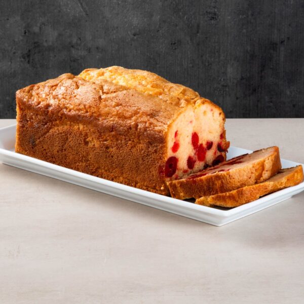 Cherry loaf cake with sliced pieces on a white plate.
