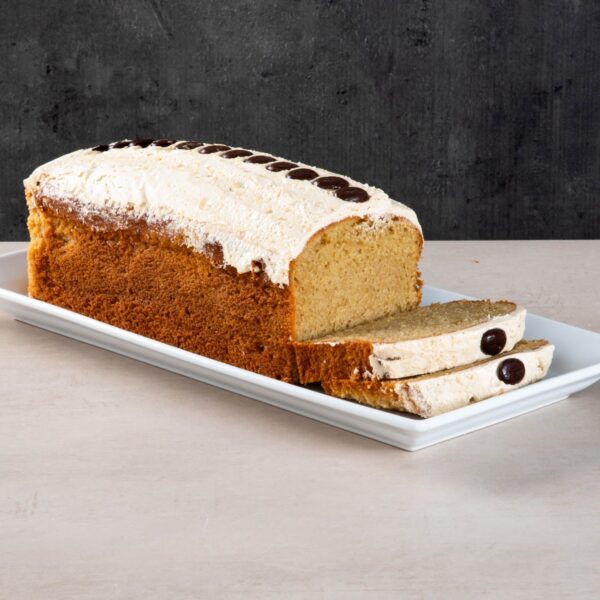 Sliced coffee loaf cake with buttercream and chocolate buttons