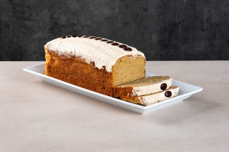 Sliced coffee loaf cake with buttercream and chocolate buttons