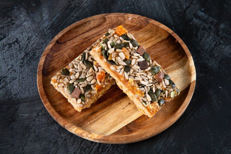 Apricot and seed flapjack slices on a wooden plate.