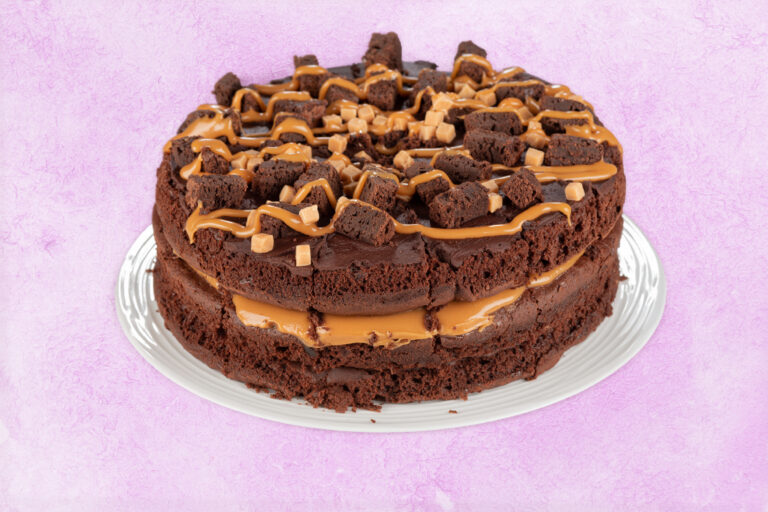 Double layer chocolate fudge cake with caramel drizzle and brownie chunks
