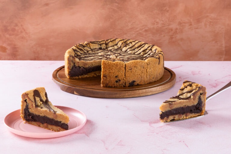Sliced chocolate brownie cookie pie with drizzle topping