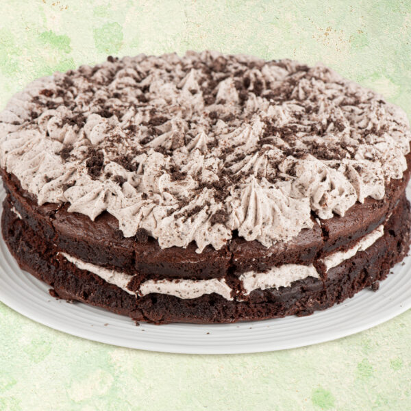 Vegan cookies and cream cake with chocolate cookie topping.
